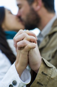 couple holding hands and kissing